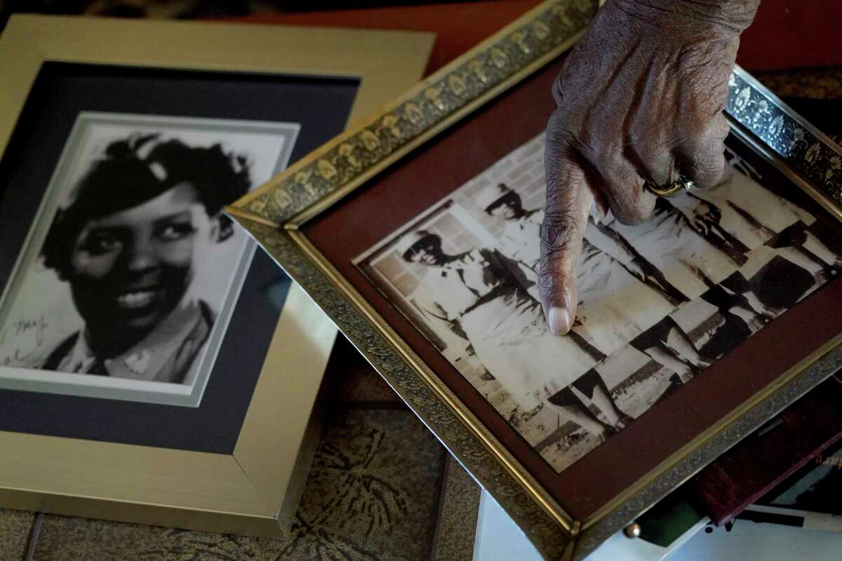 World War II veteran Maj. Fannie Griffin McClendon at her home shows images of herself in during her time in the military, Thursday, June 10, 2021, in Tempe, Ariz. McClendon had a storied history as a member of the 6888th Central Directory Postal Battalion battalion that made history as being the only all-female, black unit to serve in Europe during World War II.