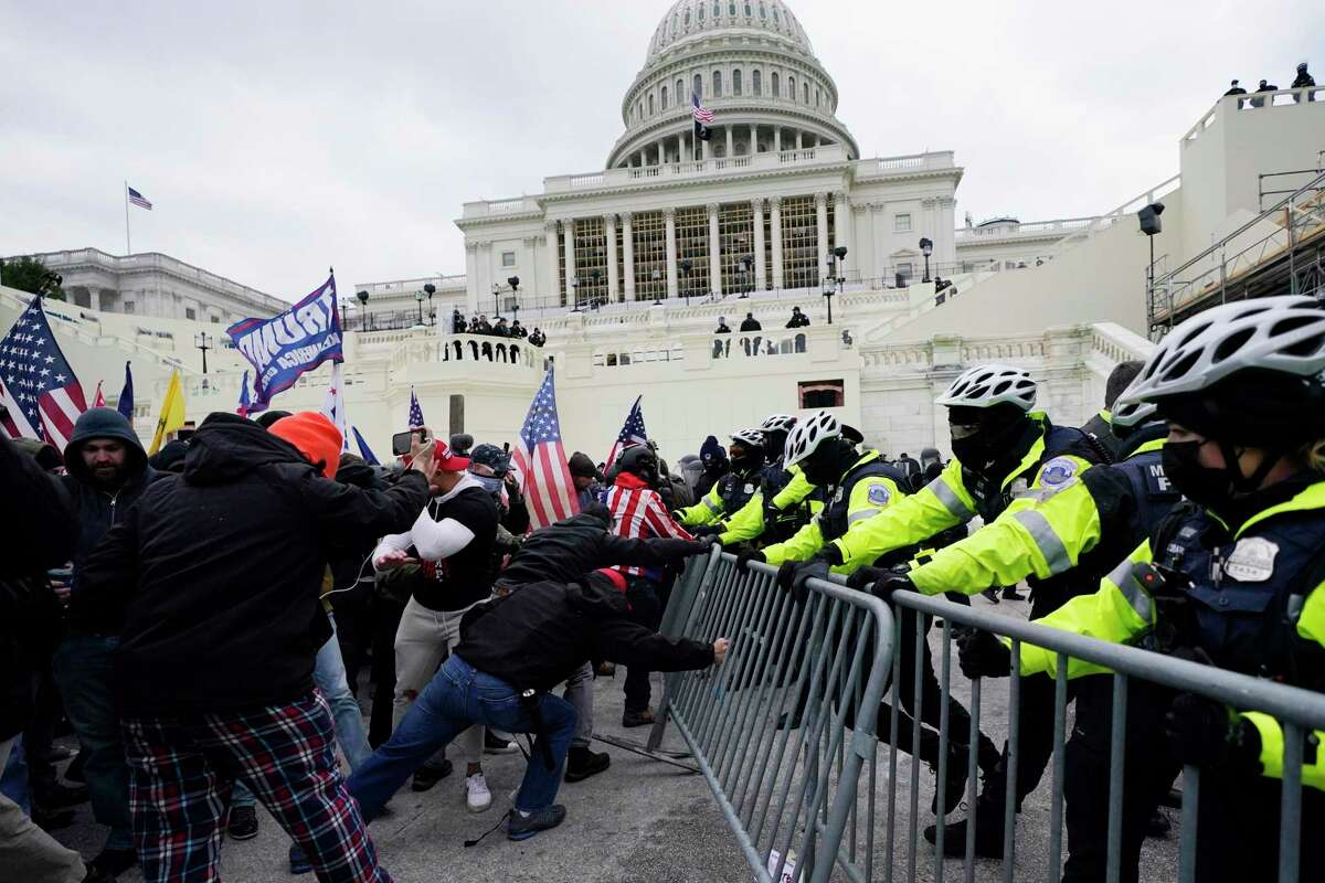 In this Jan. 6, 2021 file photo, supporters loyal to then-President Donald Trump, try to break through a police barrier at the Capitol in Washington. The FBI is searching for a Mill Valley man suspected of taking part in the January 6 riot at the U.S. Capitol.
