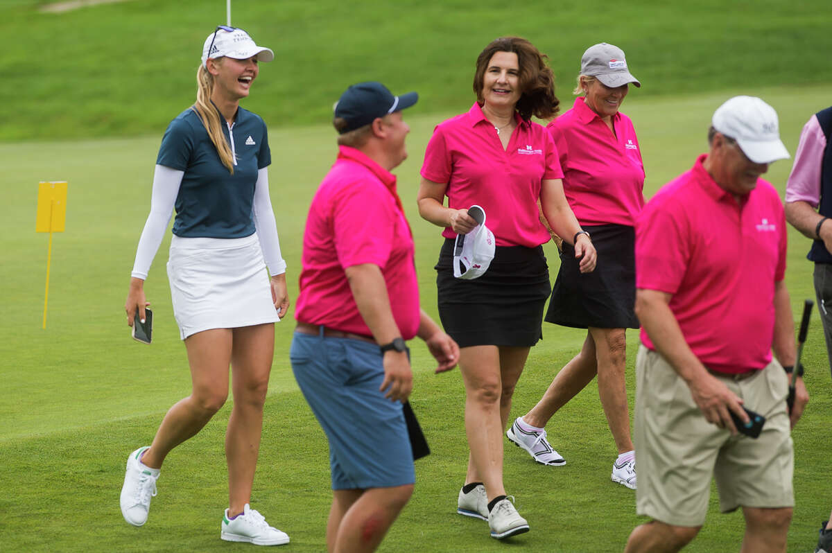 LPGA player Jessica Korda, left, chats with Jenee Velasquez, executive director of the Herbert H. and Grace A. Dow Foundation, center, during the Dow Great Lakes Bay Invitational Pro Am tournament Tuesday, July 13, 2021 at the Midland Country Club. (Katy Kildee/kkildee@mdn.net)