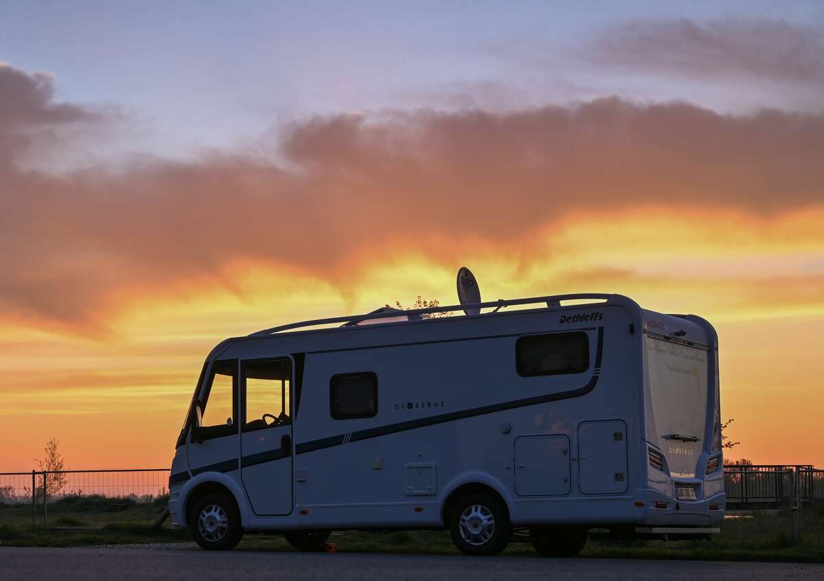 In the early morning sunrise a motorhome stands on a parking lot at the German-Polish border river Oder at the edge of the Oderbruch in East Brandenburg.