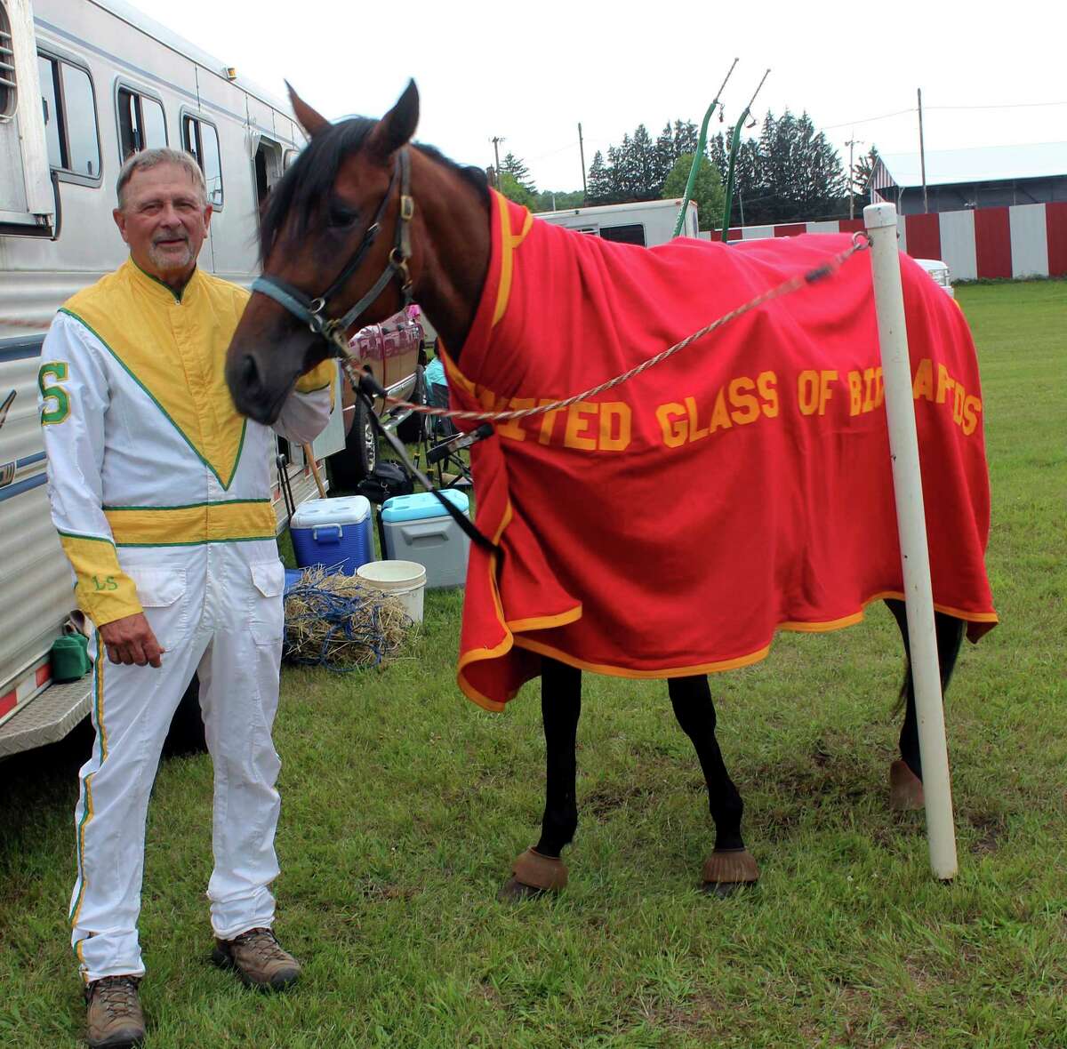 Longtime harness racer Larry Smith and his colt, Calmy Senorita, pose for a photo prior to Monday night's race. (Pioneer photo/Joe Judd)