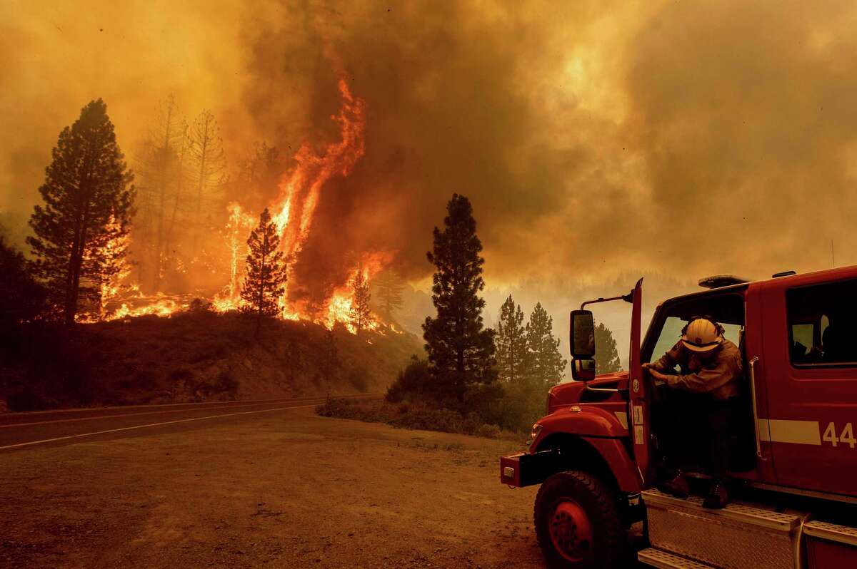 A firefighter prepares to battle the Sugar Fire, part of the Beckwourth Complex Fire, on Thursday in the Plumas National Forest.