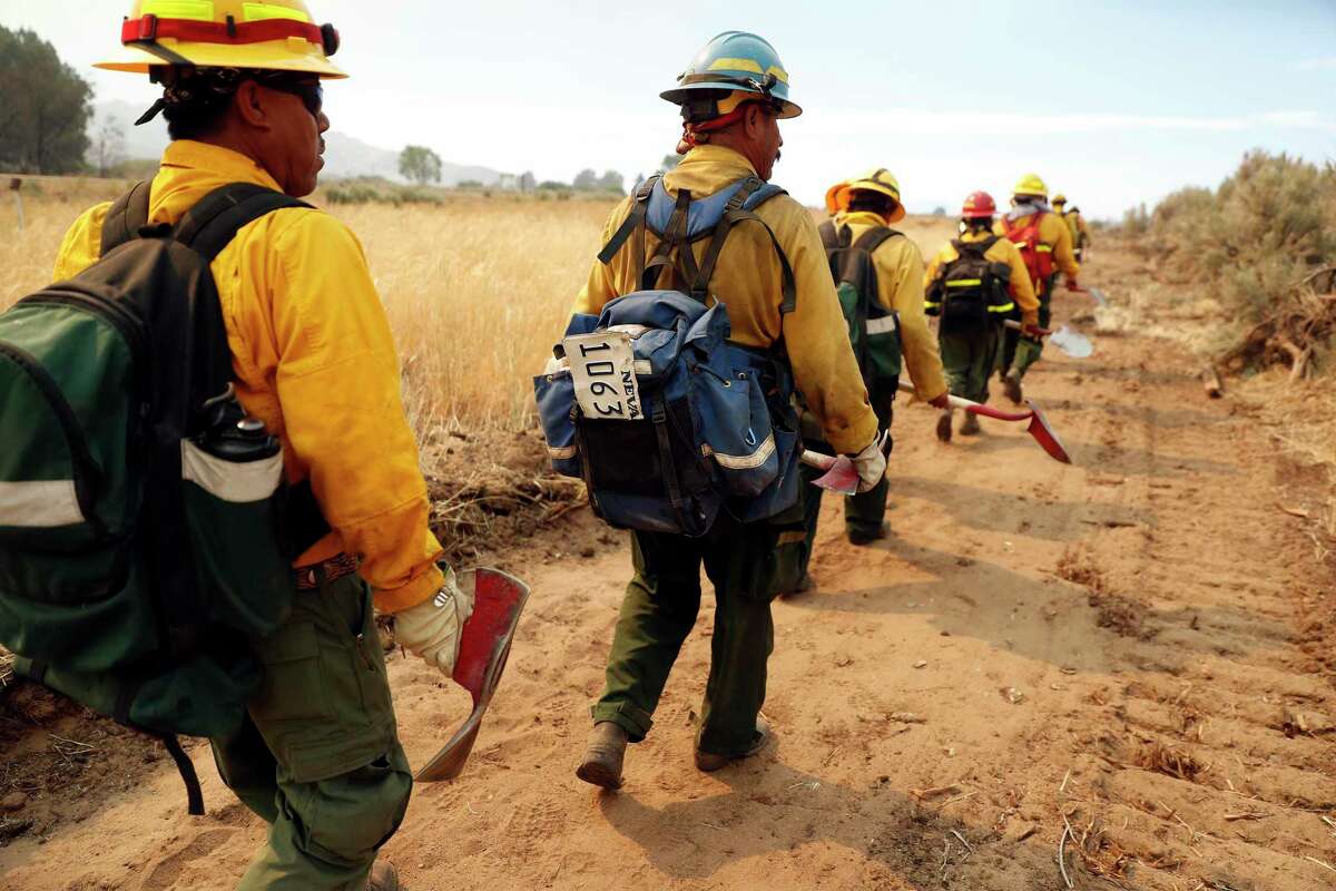 Lava River Forestry woodland firefighters head in to help fight the Beckwourth Complex fire in Lassen County on Monday.