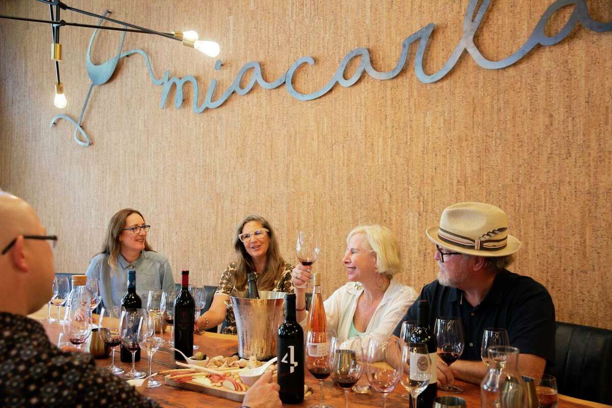 Mia Carta general manager Jim Foster, from left, Stephanie Mesher (Essere Wines), Sharon Kazan Harris (RARECAT wines), Dona Kopol Bonick (Art House Wines) and John Bonick (Art House Wines), at their shared tasting space.