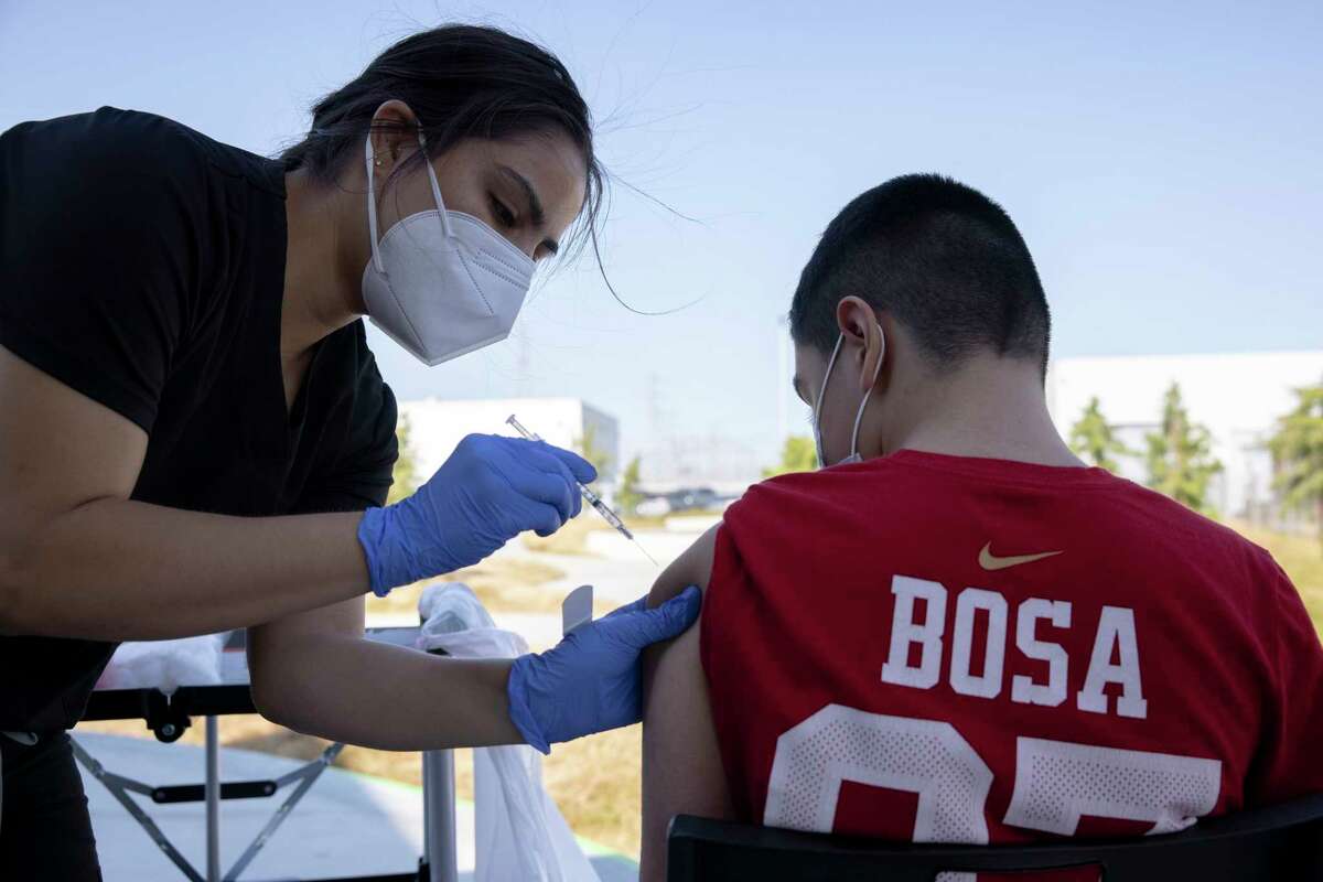 A nurse gives a vaccine shot at the East Palo Alto VAXX UP event.