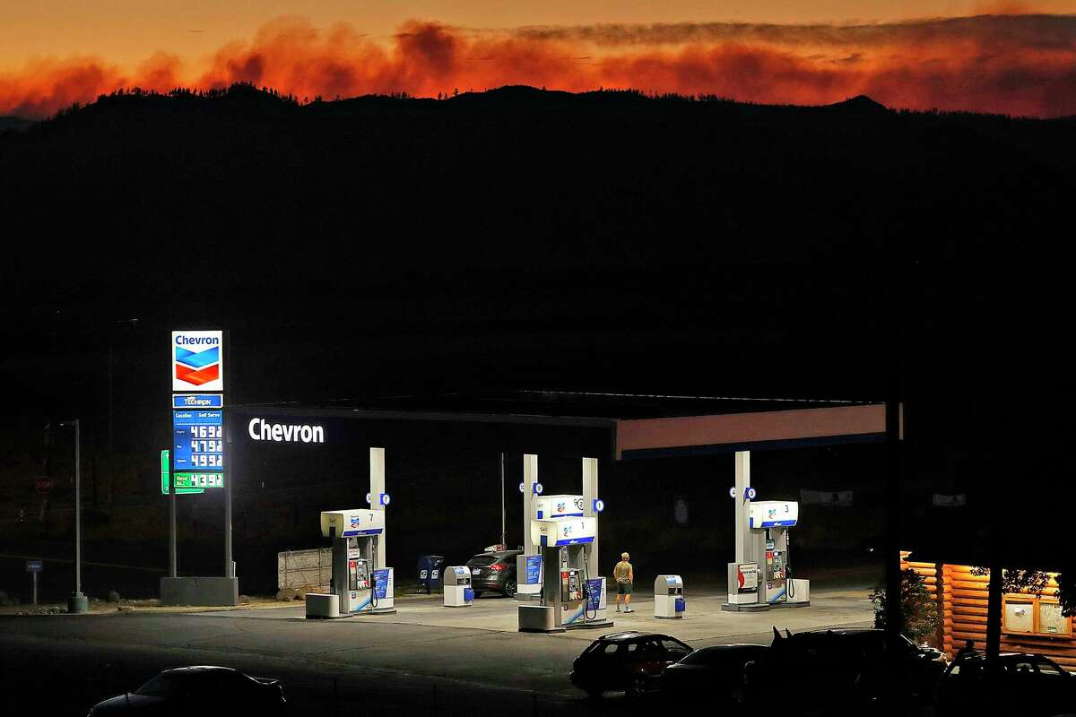 The Beckwourth Complex fire burns in the distance behind a gas station at Hallelujah Junction in Lassen County on Monday. The fire is the biggest in the state so far this year.