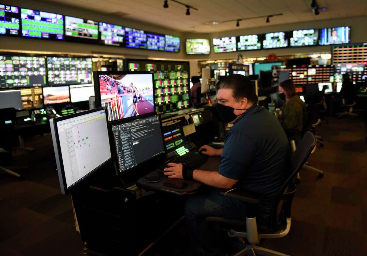 BOC manager Philip Maggio works in the broadcast operations center at NBC Sports headquarters in Stamford, Conn. Tuesday, July 13, 2021. NBC Sports is preparing to cover the Tokyo 2020 Olympic Games, which were postponed a year, in a different way than usual due to the lingering pandemic.