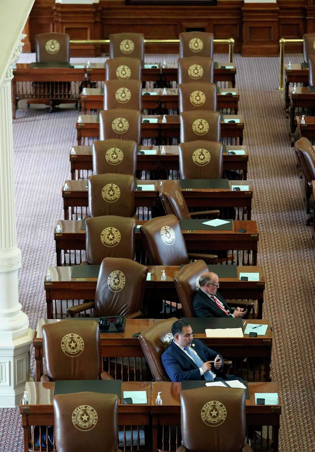 Empty seats are seen in the House Chamber at the Texas Capitol, Tuesday, July 13, 2021, in Austin, Texas. Texas Democrats left the state to block sweeping new election laws.
