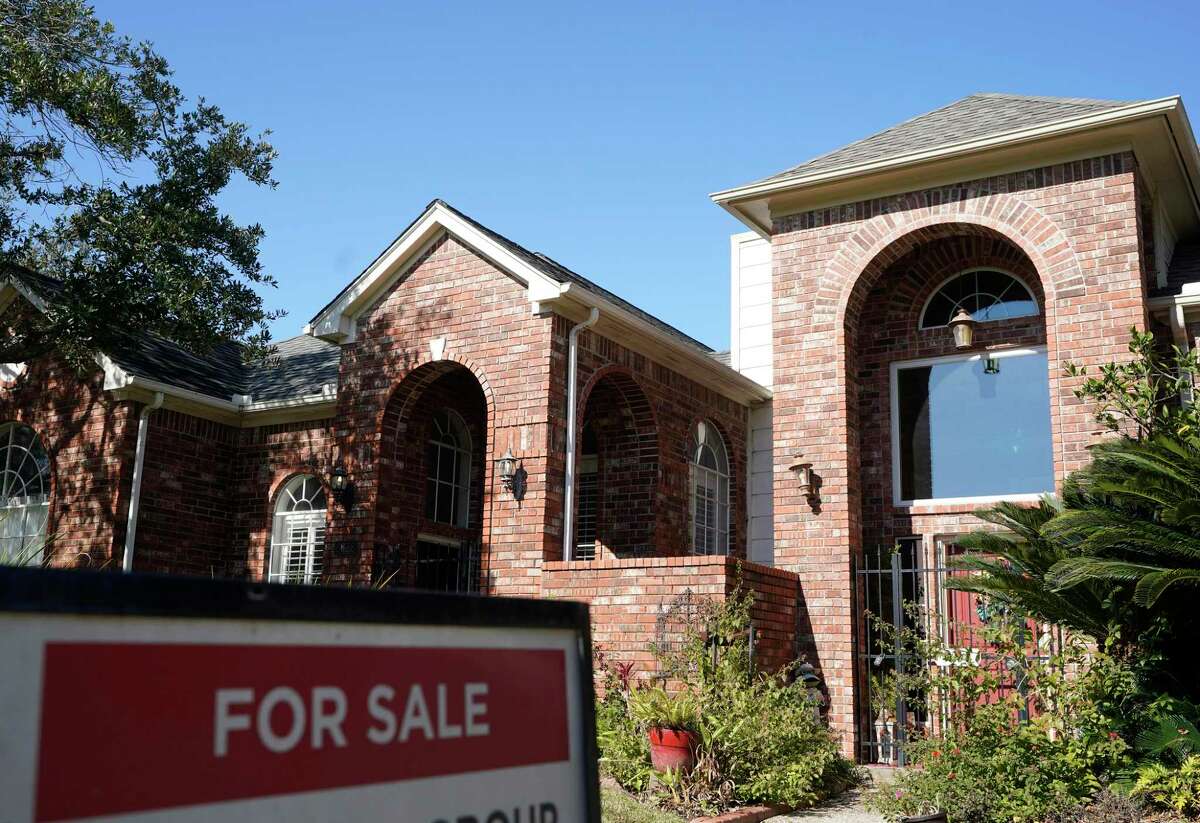 A real estate sign is shown at a home for sale, Wednesday, Jan. 13, 2021, in Houston. The metro closed out 2021 with record-breaking homes sales volume and prices, according to report from Houston Association of Realtors.