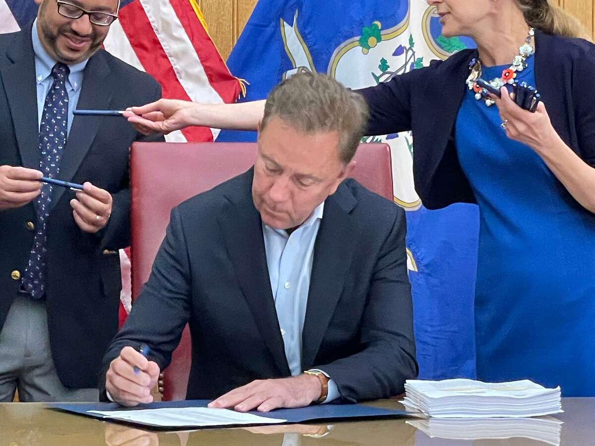 Gov. Ned Lamont signing the cannabis legalization bill into law. It was one of two passed in special session and 239 in regular session.