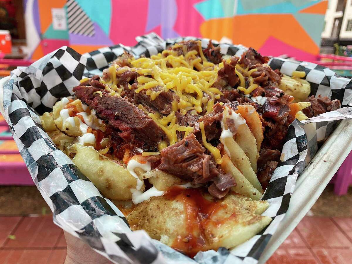 Billy Cheese Fries are waffle fries loaded with brisket chili, barbecue sauce, brisket and cheese at Holy Smoke Barbecue + Taquitos, a food trailer parked at the El Camino food truck park.