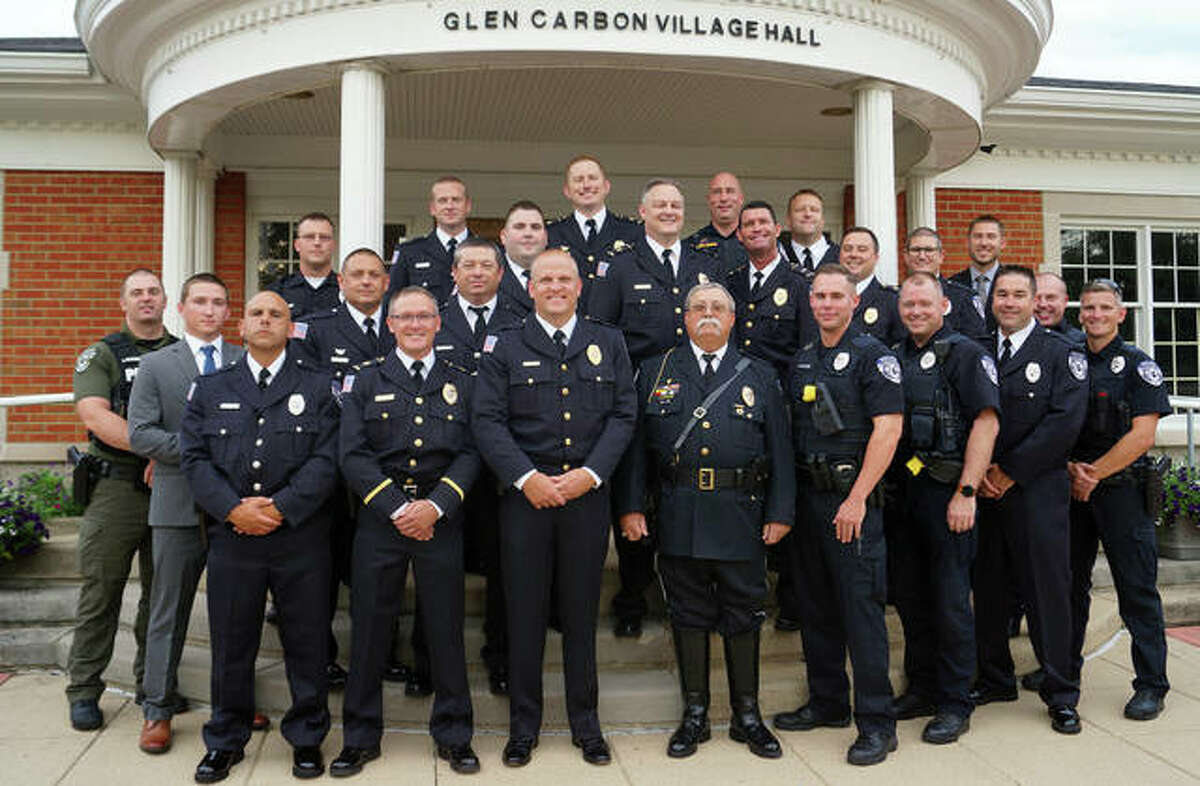 The Glen Carbon Police Department turned out in force for three of their own Tuesday, as retired sergeant James “Sarge” Jones, front row center, flanked by new Sgt. Steven Deist to his left, and the village’s newest police officer, Aaron Porter, on his right. Jones’s retirement was recognized, Deist was promoted and Porter was sworn in, respectively. Four former village police officers attended the meeting, including one from Minnesota.