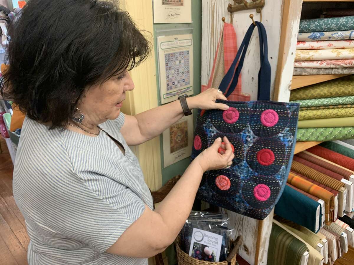 Francine shows disconnected  1  of her bags she made utilizing Japanese Sashiko stitching connected  July 14, 2021. 