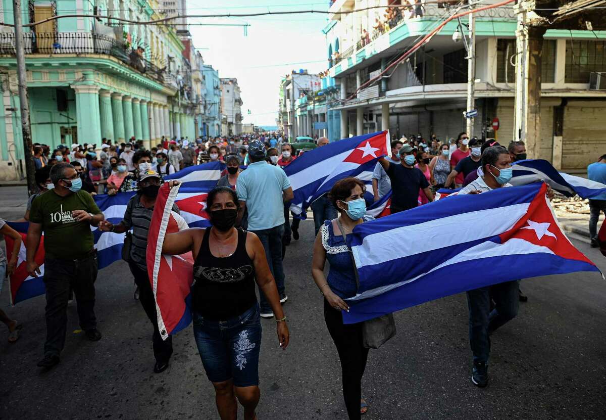 People take part in a demonstration to support the government of the Cuban President Miguel Diaz-Canel in Havana, on Sunday, July 11, 2021. Thousands of Cubans took part in rare protests Sunday against the communist government, marching through a town chanting "Down with the dictatorship" and "We want liberty." (Yamil Lage/ AFP/Getty Images/TNS)