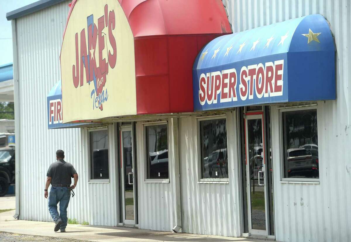 Members of the DEA, ATF, and other law enforcement agencies investigate during a raid at Jake's Fireworks Super Store and surrounding warehouses Wednesday in Nederland. Several employees were detained inside as the raid continued before eventually being released. One man was handcuffed and taken into custody. Photo taken Wednesday, July 15, 2020 Kim Brent/The Enterprise