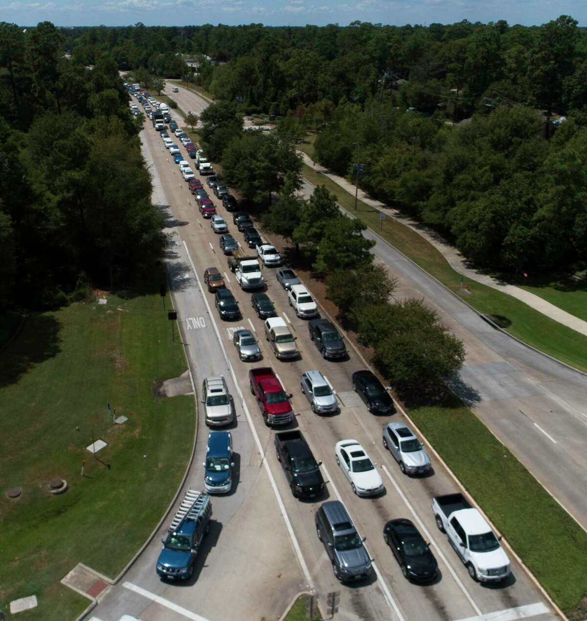 Vehicles are back up on Research Forest Drive near I-45 after power to many of the area's traffic lights went out in addition to homes and businesses, Thursday, Aug. 27, 2020. More than 100,000 customers lost power as of Thursday afternoon as Entergy-Texas began rolling power outages for its Texas customers after extensive damage to the company's transmission system caused by Hurricane Laura.