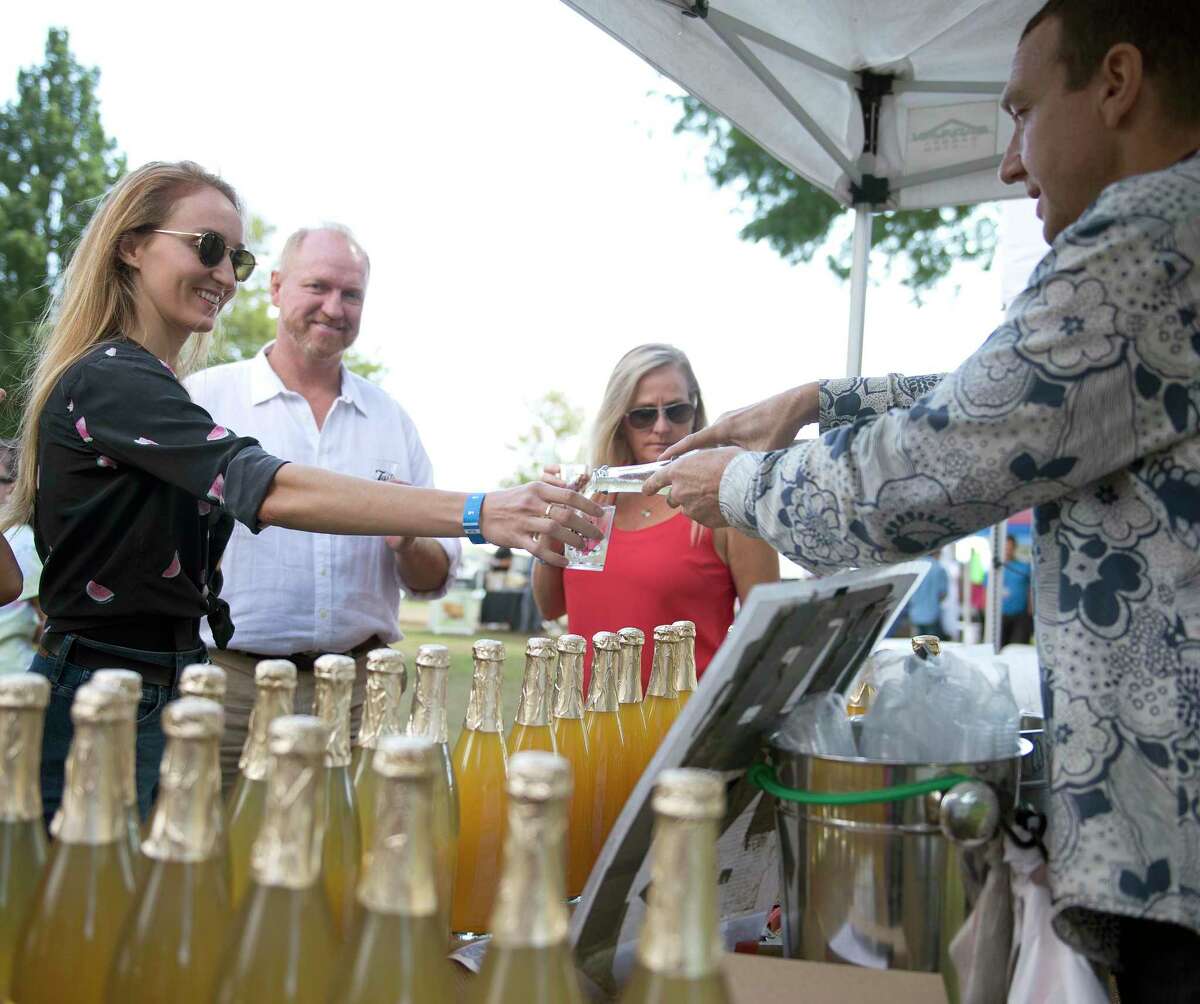 Kristi Kelly of Greenwich gets a sample of Champagne Tea Kombucha during the Last Taste of Summer Craft Beer Festival at Roger Sherman Baldwin Park in Greenwich, Conn., on Saturday, September 29, 2018.