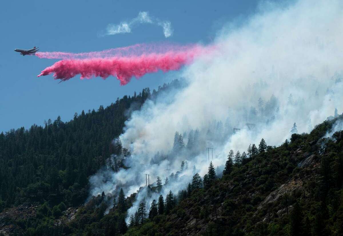 An air tanker drops fire retardant to battle the Dixie Fire in the Feather River Canyon in Plumas County.