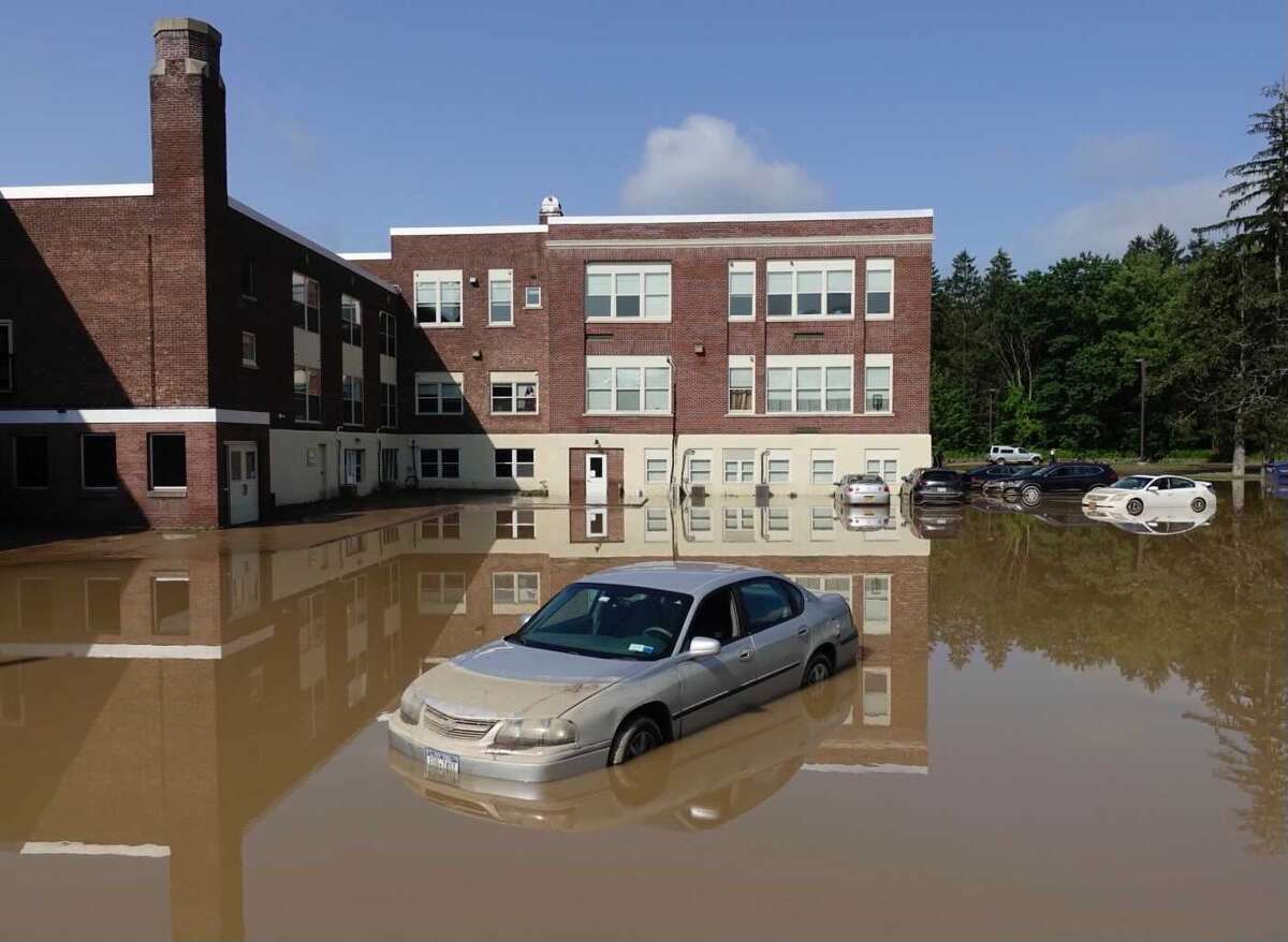 Flood waters surround the Homeroom Lofts in Averill Park Thursday, a day after torrential rains soaked parts of Rensselaer County. The town of Sand Lake offices will have someone there to assist in applying for flood assistance until Sept. 24, 2021.