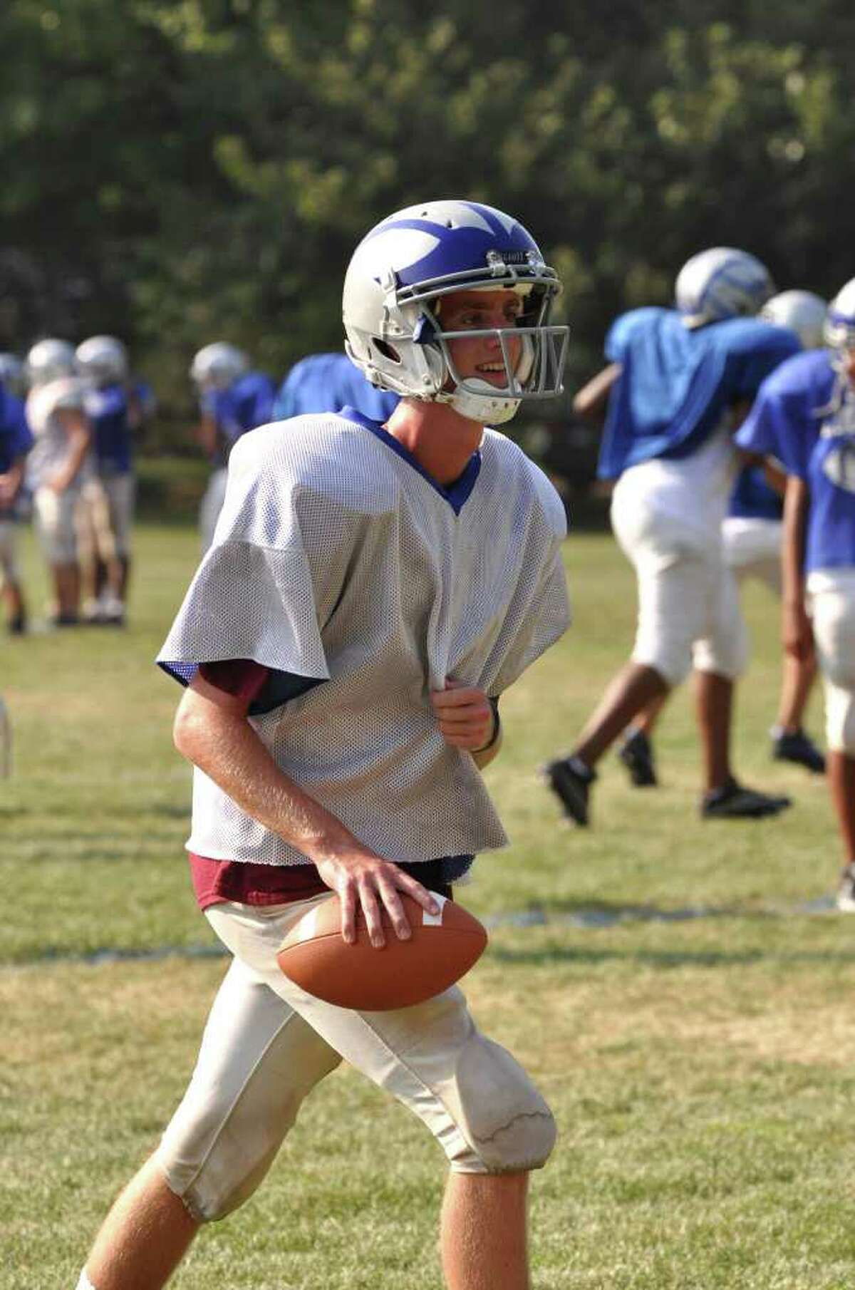 Fairfield Ludlowe football captain and quarterback John warms up his arm during practice.
