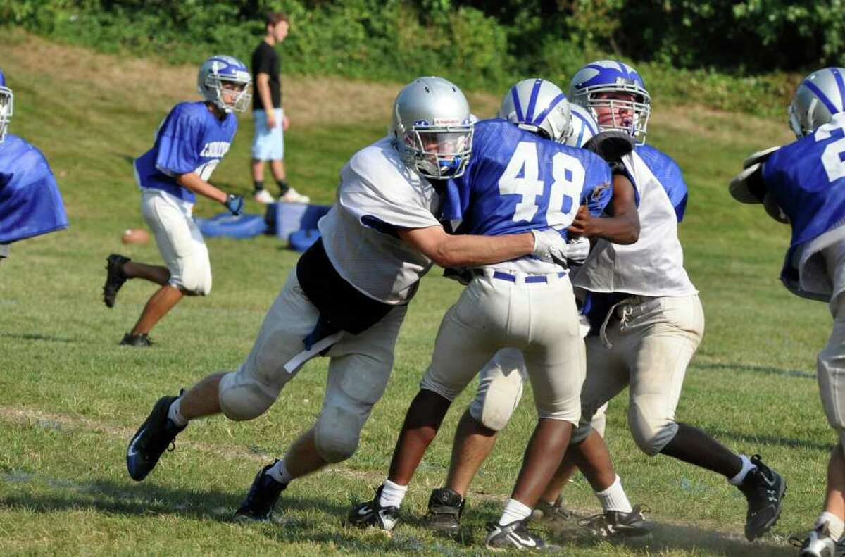 Fairfield Ludlowe football captain Chris Boardman makes a tackle during practice.