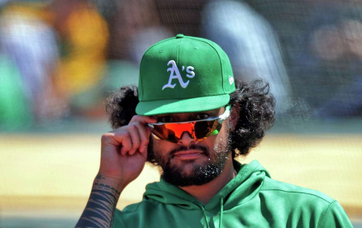 A's pitcher Sean Manaea (55) takes a peak at the fans over his glasses while in the dugout during the game as the Oakland Athletics played the Los Angeles Angels at the Coliseum in Oakland, Calif., on Sunday, May 30, 2021.