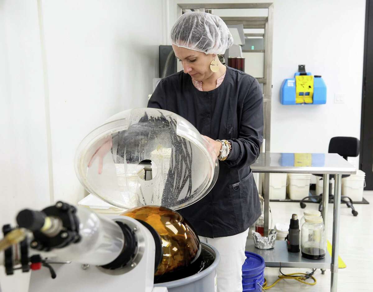 Bayou City Hemp CFO Karen Trotter opens the rotary evaporator, which creates winterized extracted hemp oil, during a tour of their facilities on Thursday, June 24, 2021, in Houston.Bayou City Hemp is one of the largest hemp manufacturing outposts to launch since Texas legalized hemp in 2019. Founding executives left the oil and gas industry after the bill passed and got into the growing CBD industry.
