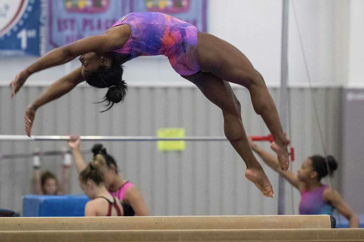 Olympic gymnast Simone Biles, working out at her home gym in early July, will compete in the balance beam in Tokyo on Tuesday.