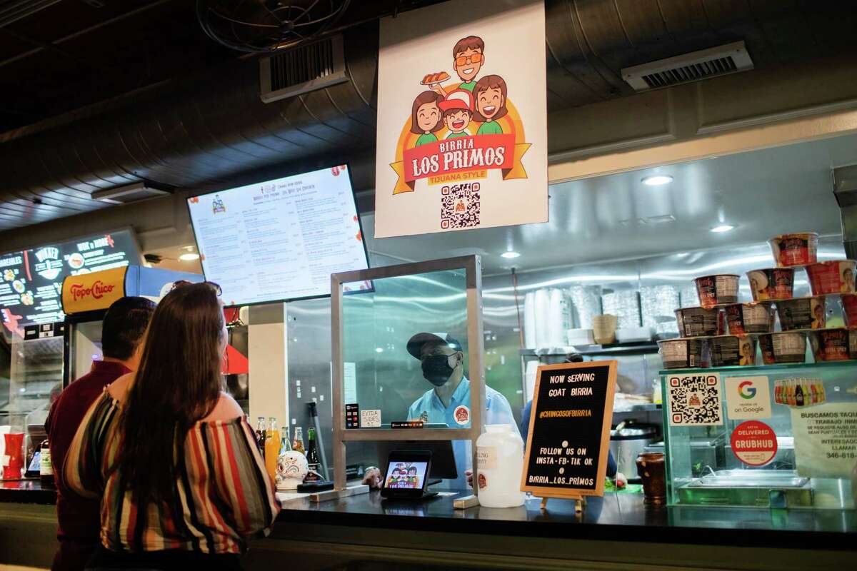Birria Los Primos owner Oscar Garcia takes an other from his clients, Thursday, July 15, 2021, in Houston. The management of the restaurant says Uber Eats has ripped them off to the tune of $20K.