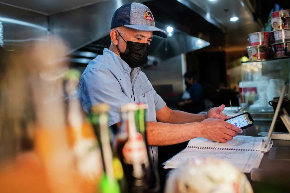 Birria Los Primos owner Oscar Garcia revises his agenda while working on his business, Thursday, July 15, 2021, in Houston. The management of the restaurant says Uber Eats has ripped them off to the tune of $20K.