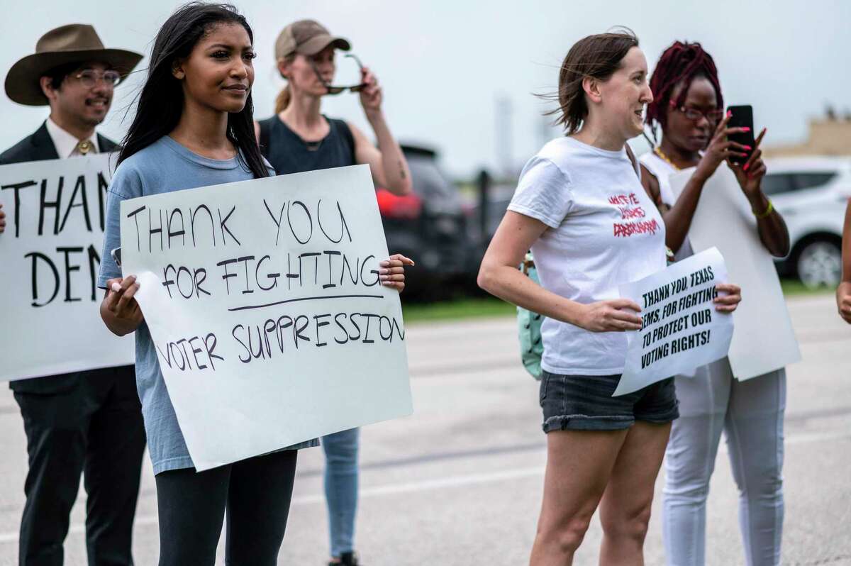 Supporters for Texas Democrats stand outside the Austin Bergstrom International Airport on Monday, July 12, 2021 in Austin, Texas. Texas Democrats fled the state to prevent a quorum after protesting SB7, a voting protection bill that Democrats have criticized as being too restrictive. (Sergio Flores/Getty Images/TNS)