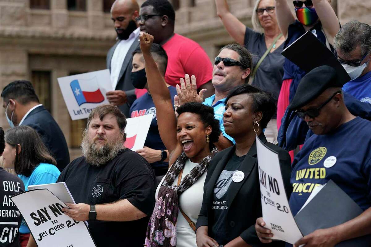Demonstrators protest proposed voting bill on the steps of the Texas Capitol, Tuesday, July 13, 2021, in Austin, Texas. Texas Democrats left the state to block sweeping new election laws, while Republican Gov. Greg Abbott threatened them with arrest the moment they return. (AP Photo/Eric Gay)