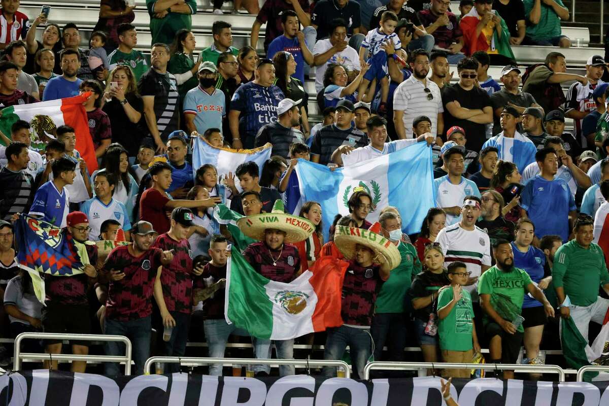 Mexico and Guatemala fans cheer for their teams during the first half of a CONCACAF Gold Cup Group A soccer match in Dallas, Wednesday, July 14, 2021. (AP Photo/Michael Ainsworth)
