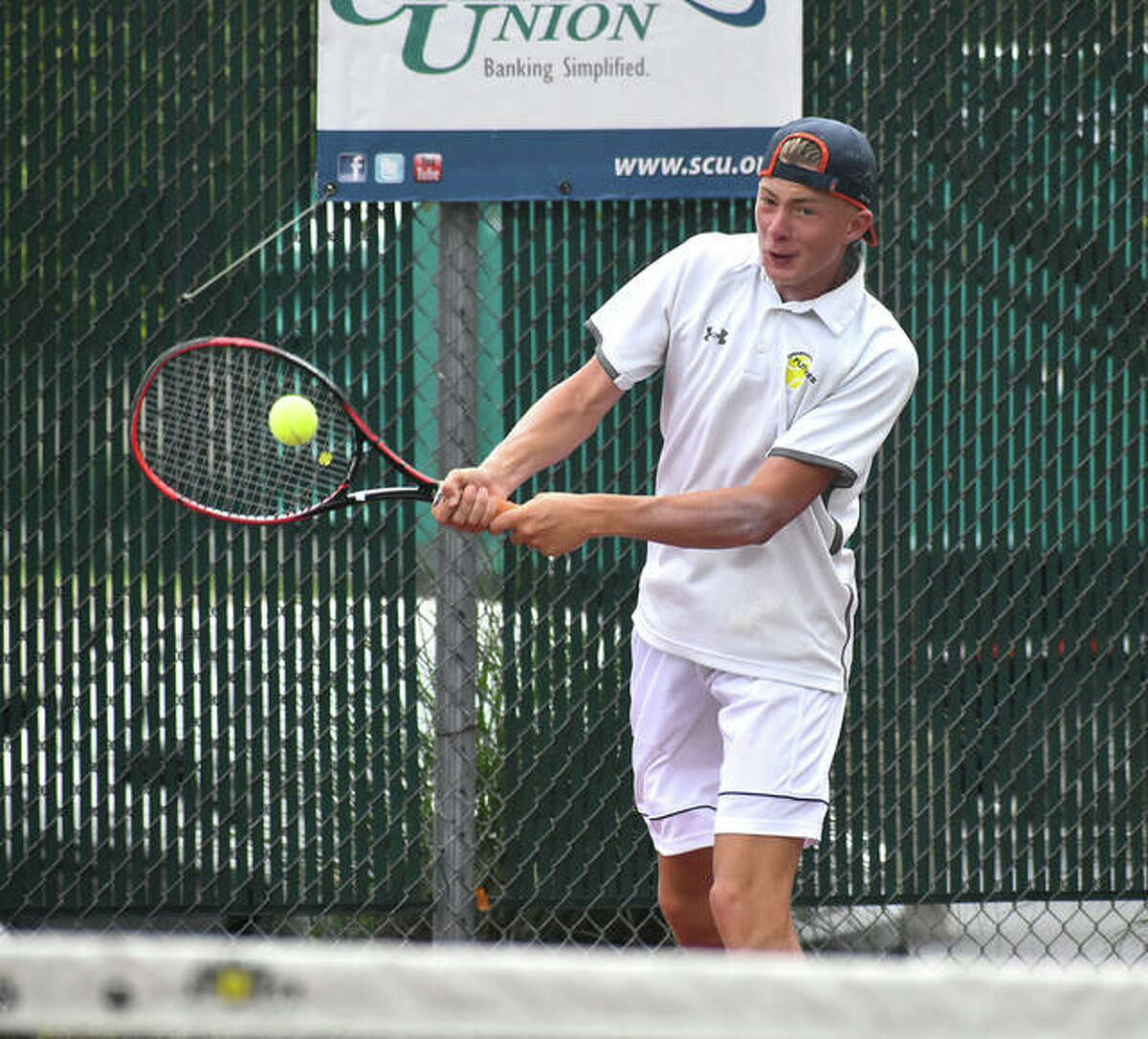 Edwardsville’s Colton Hulme hits a backhand shot during his second-round match against University of Illinois All-American Siphos Montsi at the Edwardsville Wild Card Tournament on Thursday.