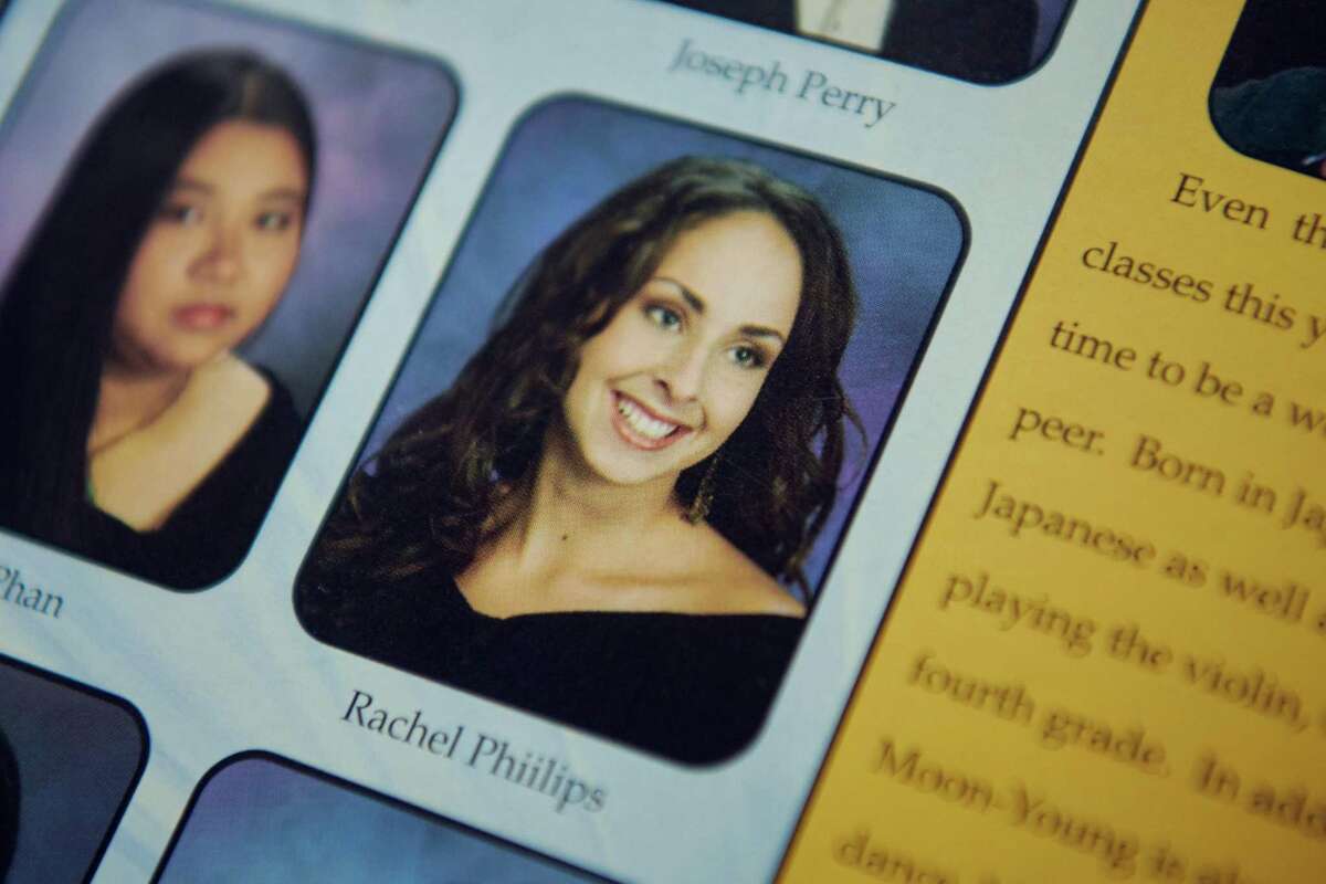 Rachel Phillips displays her 2002-03 Berkeley High School yearbook at her mother’s home in Oregon City, Ore. Phillips is suing the Berkeley Unified School District and former chemistry teacher and football coach Matthew Bissell. The suit says Bissell assaulted and harassed her and that the district failed to protect her despite repeated complaints.
