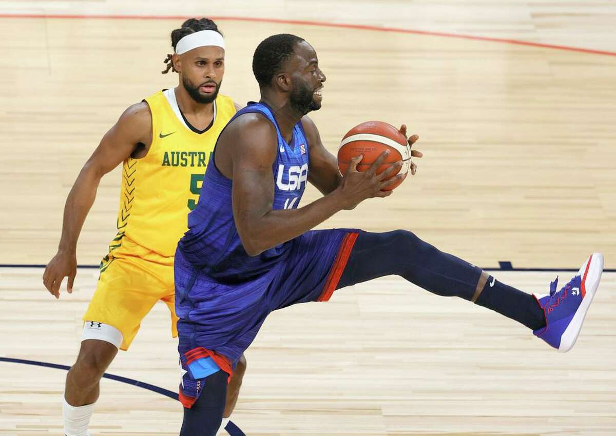 LAS VEGAS, NEVADA - JULY 12: Draymond Green #14 of the United States catches a pass against Patty Mills #5 of the Australia Boomers during an exhibition game at Michelob Ultra Arena ahead of the Tokyo Olympic Games on July 12, 2021 in Las Vegas, Nevada. (Photo by Ethan Miller/Getty Images)