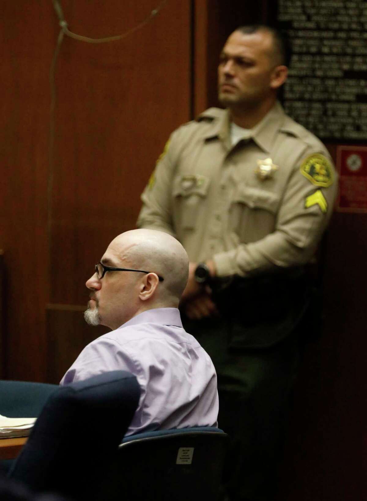 FILE - In this May 29, 2019, file photo, Michael Gargiulo, sitting, listens to the testimony of Ashton Kutcher during Gargiulo's murder trial at Los Angeles Superior Court. Gargiulo has pleaded not guilty to two counts of murder and an attempted-murder charge stemming from attacks in the Los Angeles area between 2001 and 2008, including the death of Kutcher's former girlfriend, 22-year-old Ashley Ellerin. (Genaro Molina/Los Angeles Times via AP, Pool, File)