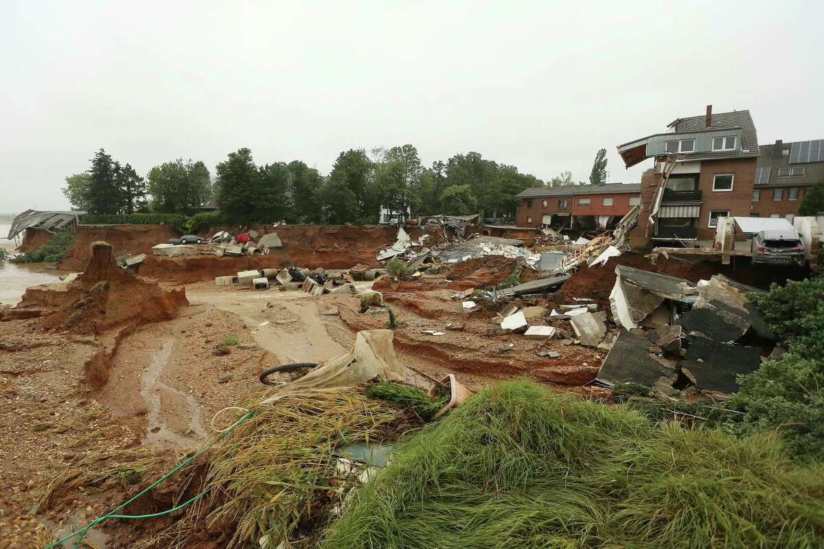 Debris of collapsed houses is pictures in the Blessem district of Erftstadt, Germany, Friday, July 16, 2021. Heavy rains caused mudslides and flooding in the western part of Germany. Multiple have died and dozens are missing as severe flooding in Germany and Belgium turned streams and streets into raging, debris-filled torrents that swept away cars and toppled houses. (David Young/dpa via AP)