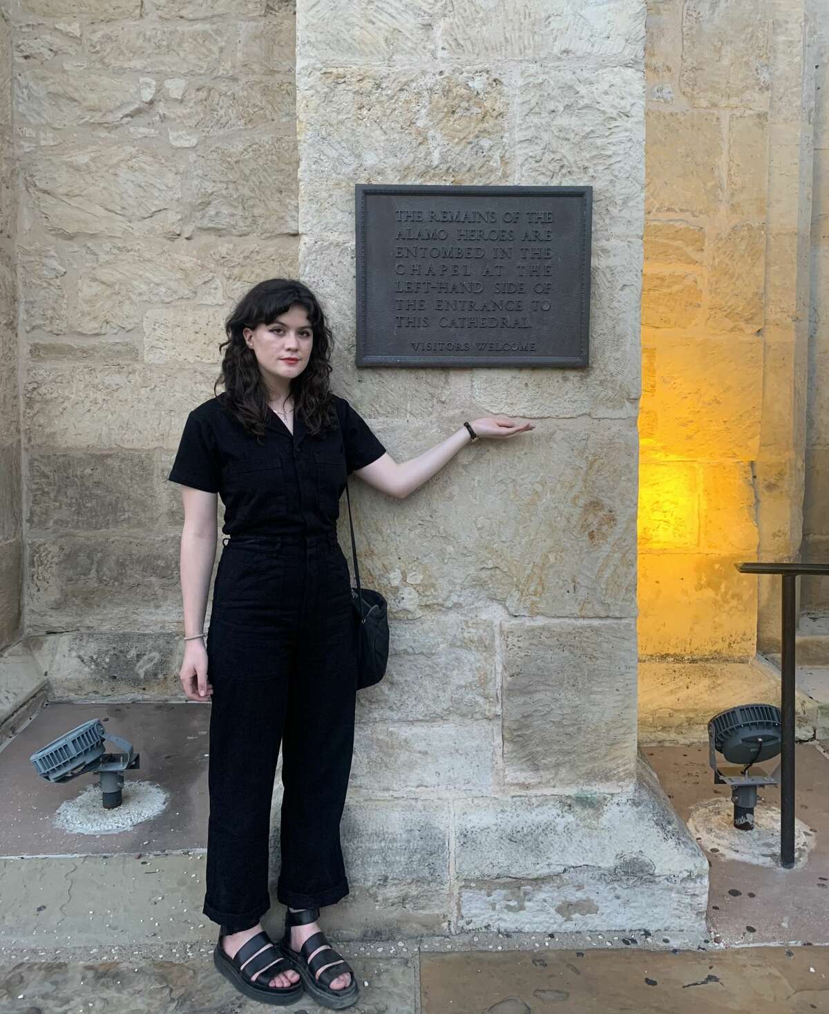 Me standing before a plaque that warns parishioners and passerby of the Alamo-era remains entombed inside of San Fernando Cathedral. 