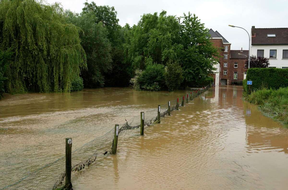 A house and field are flooded in Hoegaarden, Belgium, on Friday, July 16, 2021. Severe flooding in Germany and Belgium has turned streams and streets into raging torrents that have swept away cars and caused houses to collapse.