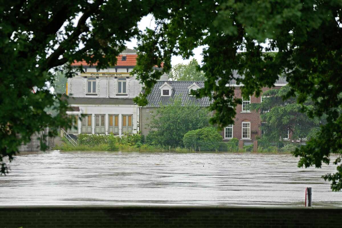The Meuse River is level with its barrier after flooding in Maaseik on Friday, July 16, 2021. Severe flooding in Germany and Belgium has turned streams and streets into raging torrents that have swept away cars and caused houses to collapse.