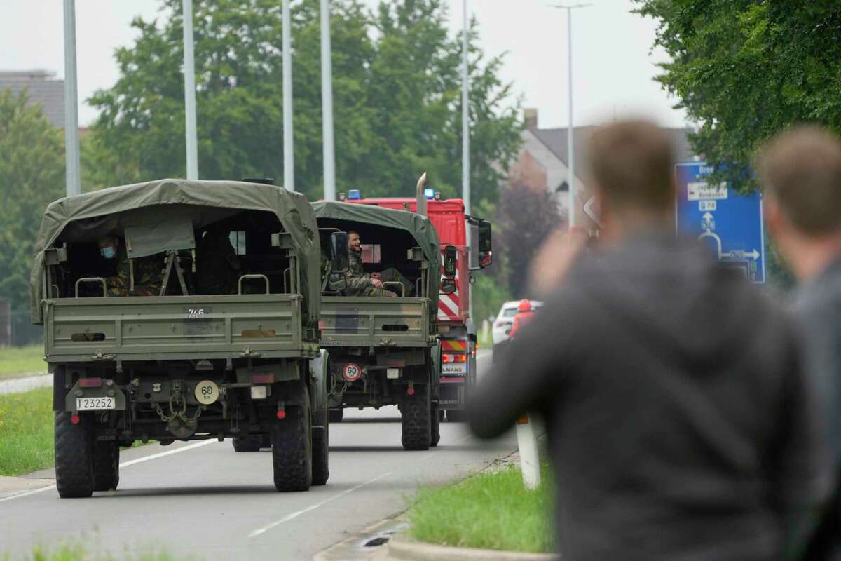 Belgian Army soldiers help with evacuations as the River Meuse rises after flooding in Maaseik on Friday, July 16, 2021. Severe flooding in Germany and Belgium has turned streams and streets into raging torrents that have swept away cars and caused houses to collapse.