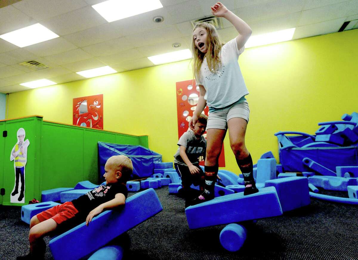 Izzy Caple balances on a foam teeter totter she created while playing with family, including brothers Porter, Otto and Britt and mom Nikki, at the Beaumont Children's Museum Thursday morning. Photo taken Thursday, September 24, 2020 Kim Brent/The Enterprise