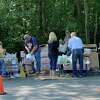 Volunteers pass out groceries to waiting vehicles during a pop-up food pantry on Wednesday at the Ubly Fox Hunters Club. (Mark Birdsall/Huron Daily Tribune)