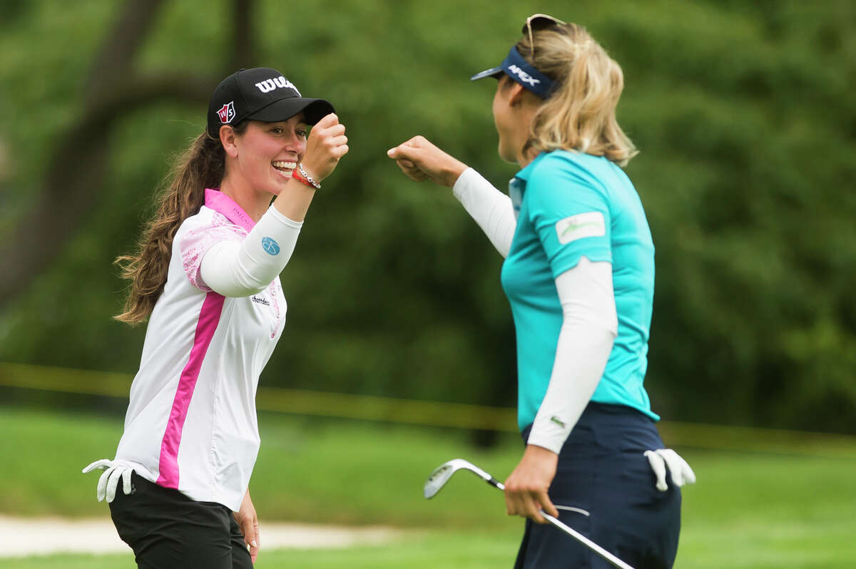 LPGA player Nuria Iturrioz, left, fist bumps her playing partner, Celine Herbin, right, as they compete in the third round of play during the Dow Great Lakes Bay Invitational Friday, July 16, 2021 at the Midland Country Club. (Katy Kildee/kkildee@mdn.net)