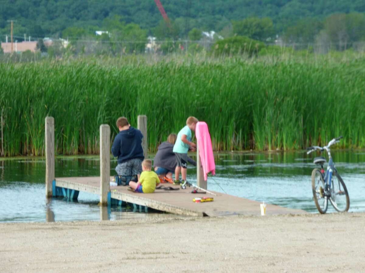 A group of young anglers try their luck fishing off a dock at Penny Park. (News Advocate file photo)