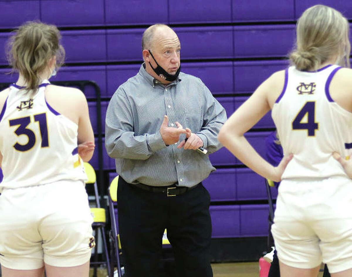 CM coach Mike Arbuthnot (middle) talks with his team during a mask break in a game last season in Bethalto. Arbuthnot, in his first season at Civic Memorial, is the 2021 Telegraph Large-Schools Girls Basketball Coach of the Year.
