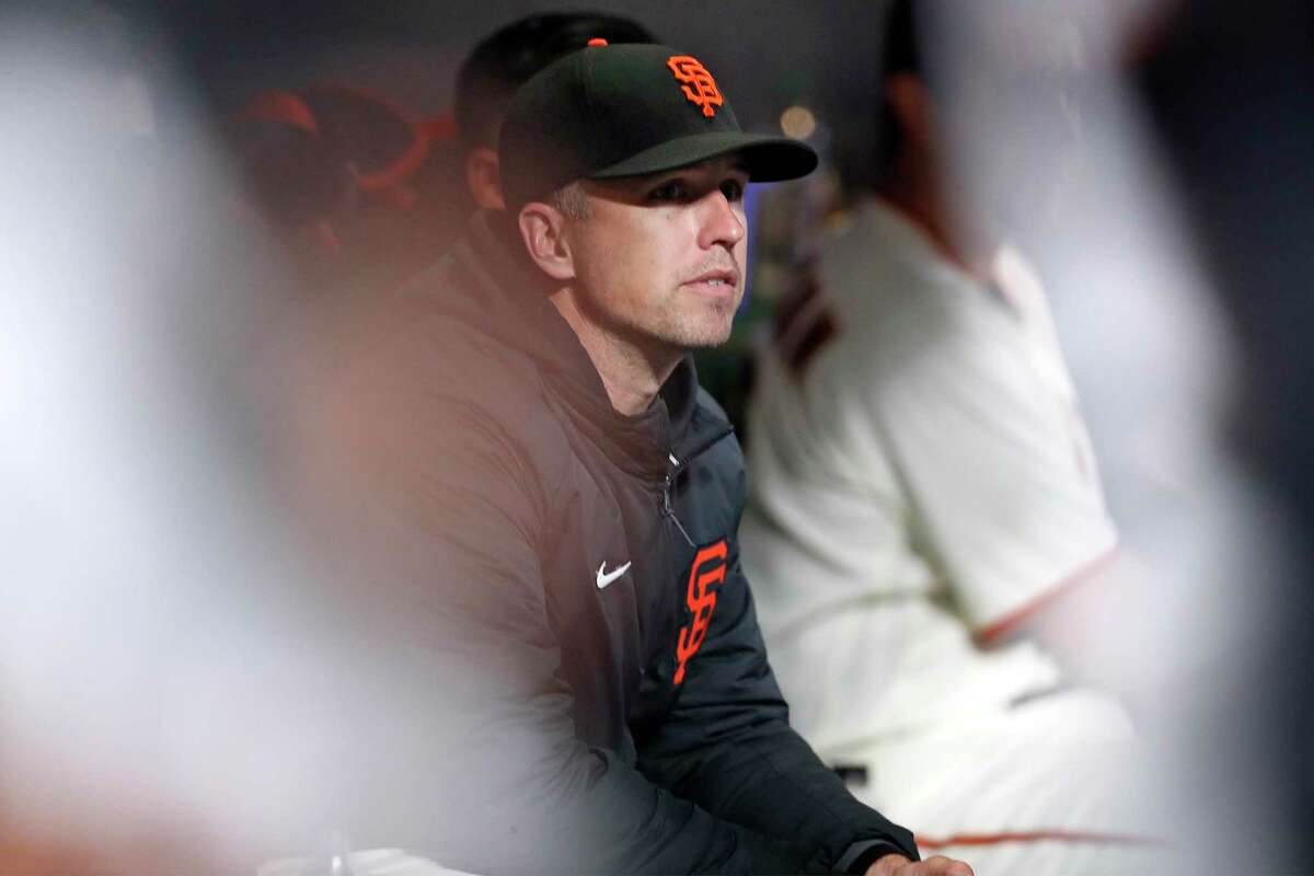 San Francisco Giants' Buster Posey watches from bench as Giants play St. Louis Cardinals during MLB game at Oracle Park in San Francisco, Calif., on Tuesday, July 6, 2021.