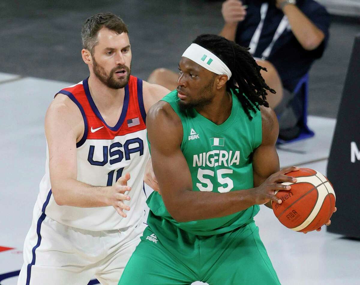Precious Achiuwa (55) of Nigeria is guarded by Kevin Love #11 of the United States during an exhibition game at Michelob ULTRA Arena ahead of the Tokyo Olympic Games on July 10, 2021 in Las Vegas, Nevada. Nigeria defeated the United States 90-87. (Ethan Miller/Getty Images/TNS)