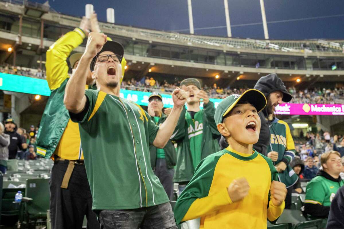 10-year-old Jonathan Catano (front) cheers as the Oakland Athletics take on the Cleveland Indians at RingCentral Coliseum on Friday.
